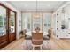 Open dining room with a round wooden table, woven chairs, wood floors, and lots of natural light at 337 Evian Way, Mount Pleasant, SC 29464
