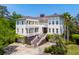 Stunning multi-story home boasts a white exterior, multi-level balconies, and a meticulously landscaped front yard at 337 Evian Way, Mount Pleasant, SC 29464