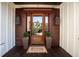 Elegant front entrance featuring a wood door, stylish sconces, and a welcoming mat at 337 Evian Way, Mount Pleasant, SC 29464