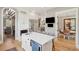 Open concept kitchen with white cabinetry, stainless appliances, island with seating, and hardwood floors at 337 Evian Way, Mount Pleasant, SC 29464