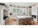 Well-lit kitchen features white cabinets, stainless appliances, an island with seating, and hardwood floors at 337 Evian Way, Mount Pleasant, SC 29464
