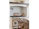Close-up view of the kitchen range with a decorative backsplash, a custom hood, and seating at the island at 337 Evian Way, Mount Pleasant, SC 29464