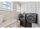 Well-lit laundry room with modern washer and dryer, granite countertops, and ample cabinet space at 337 Evian Way, Mount Pleasant, SC 29464
