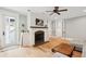 Bright living room with fireplace, light wood floors, a ceiling fan, and glass doors to the outside at 337 Evian Way, Mount Pleasant, SC 29464