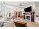 Spacious living room with fireplace, wood floors, ceiling fans, comfortable sofa and lounge chairs at 337 Evian Way, Mount Pleasant, SC 29464