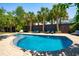 Sparkling in-ground pool with lounge chairs and palm trees, creating a resort-like backyard oasis at 337 Evian Way, Mount Pleasant, SC 29464