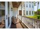 Inviting covered porch with outdoor seating and a dark stained wood ceiling with ceiling fan at 337 Evian Way, Mount Pleasant, SC 29464