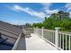 Outdoor rooftop deck with an Adirondack chair, with views of greenery and blue skies at 337 Evian Way, Mount Pleasant, SC 29464