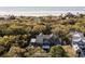 Aerial view of an upscale home surrounded by lush greenery near the beach, offering privacy and stunning natural views at 34 Eugenia Ave, Kiawah Island, SC 29455