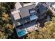 High angle view of a house from above, featuring a spacious deck with a pool, dining area, and well-manicured yard at 34 Eugenia Ave, Kiawah Island, SC 29455