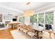 Open-concept dining room with modern light fixture, hardwood floors, and sliding doors to the outdoor space at 34 Eugenia Ave, Kiawah Island, SC 29455