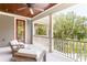 Cozy porch with seating area, ceiling fan, and views of the surrounding trees at 34 Eugenia Ave, Kiawah Island, SC 29455