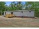 Back exterior showcasing sliding glass doors that open onto the wooden deck at 409 Peacock Ln, Summerville, SC 29483