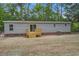 Exterior view of the back of the home, featuring a sliding door to the wooden deck at 409 Peacock Ln, Summerville, SC 29483