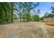 Expansive backyard featuring a gravel base and bordered by mature trees and neighboring properties at 409 Peacock Ln, Summerville, SC 29483