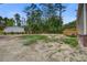 Spacious backyard featuring a wooden deck and abundant tree coverage around the property at 409 Peacock Ln, Summerville, SC 29483