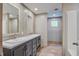 Double sink bathroom with modern vanity and a tiled wall, leading to a closet at 409 Peacock Ln, Summerville, SC 29483