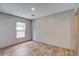 Bedroom with wood-look flooring, a window, and neutral wall paint creating a calm space at 409 Peacock Ln, Summerville, SC 29483