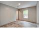 Bright bedroom features wood-look flooring and a window letting in natural light at 409 Peacock Ln, Summerville, SC 29483