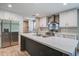 Modern kitchen with stainless steel appliances, island with sink, and white cabinets at 409 Peacock Ln, Summerville, SC 29483