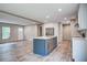 Bright, open-concept kitchen with stainless steel appliances, an island, and plank flooring at 409 Peacock Ln, Summerville, SC 29483