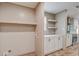 Convenient laundry room with shelving, cabinets, and adjacent kitchen access at 409 Peacock Ln, Summerville, SC 29483