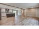 Spacious open-concept living space showcasing plank flooring, a kitchen island, and modern finishes throughout the home at 409 Peacock Ln, Summerville, SC 29483