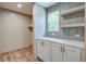 Bright pantry area with a window, shelving, and white cabinetry at 409 Peacock Ln, Summerville, SC 29483