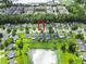 Beautiful aerial view of a neighborhood with a pond, lawns, and a house outlined in red at 5276 Copley Cir, Summerville, SC 29485