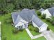 Aerial view of a home with a well-manicured lawn, an attached garage and driveway at 5276 Copley Cir, Summerville, SC 29485