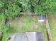 An aerial view of a fenced backyard featuring a spacious lawn and a storage shed at 5276 Copley Cir, Summerville, SC 29485