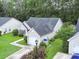 An aerial view of a home with a well-maintained lawn, attached garage, and driveway at 5276 Copley Cir, Summerville, SC 29485