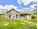 Large backyard with a sunroom, storage shed, wood fence, green lawn, and patio with a grill at 5276 Copley Cir, Summerville, SC 29485