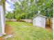 Backyard featuring an ample lawn, storage shed, and a wooden privacy fence at 5276 Copley Cir, Summerville, SC 29485