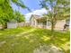 Lush backyard featuring a wooden fence, small storage shed, well-kept lawn, and beautiful shade trees at 5276 Copley Cir, Summerville, SC 29485