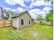 The backyard features a spacious lawn, with a wooden privacy fence, and exterior of the house at 5276 Copley Cir, Summerville, SC 29485