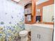 Cozy bathroom featuring a floral shower curtain, vanity with storage, and built-in shelves and towel rack at 5276 Copley Cir, Summerville, SC 29485