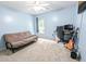 Carpeted bedroom with a futon, desk, computer, guitar, and ceiling fan with a light blue paint scheme at 5276 Copley Cir, Summerville, SC 29485