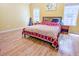 Sun-filled main bedroom featuring two windows, neutral walls, and wood floors at 5276 Copley Cir, Summerville, SC 29485