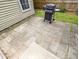Paver patio with a grill provides an ideal space for outdoor cooking and entertaining beside the home at 5276 Copley Cir, Summerville, SC 29485