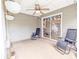 Relaxing sunroom with tiled floors, ceiling fan, hanging plants, and patio furniture for enjoying the outdoors at 5276 Copley Cir, Summerville, SC 29485