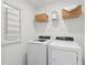 Modern laundry room with new appliances and storage shelves, creating an efficient and organized space at 5583 Ruby Falls Dr, North Charleston, SC 29420
