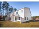 View of a two story home with white siding, covered porch, and a spacious backyard at 5585 Ruby Falls Dr, North Charleston, SC 29420