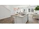Open-concept kitchen featuring a spacious island, modern appliances, and seamless flow into the adjacent living area at 5585 Ruby Falls Dr, North Charleston, SC 29420