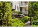 Exterior view of a charming home with a well-maintained garden, patio, and a lush green landscape at 6 Judith St, Charleston, SC 29403