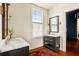Bright bathroom with marble countertops, double vanity, stylish fixtures, and wood floors at 6 Judith St, Charleston, SC 29403