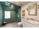 Modern bathroom featuring a beautiful shower with green tiles and modern fixtures, complemented by a stylish vanity and decor at 6 Judith St, Charleston, SC 29403