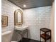 Stylish bathroom with classic white subway tile, pedestal sink, decorative mirror, and a vintage-inspired design at 6 Judith St, Charleston, SC 29403