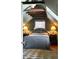 A cozy bedroom features unique wood beam architecture, soft natural light, and simple, stylish bedside decor at 6 Judith St, Charleston, SC 29403