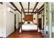 This bedroom has a four-poster bed, wood floors, exposed beam ceilings, a decorative wall tapestry, and is spacious at 6 Judith St, Charleston, SC 29403